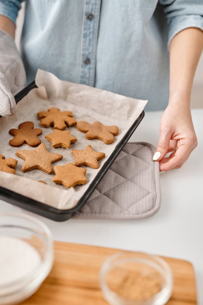 Services Close-up of freshly baked gingerbread cookies on a tray in a home kitchen.